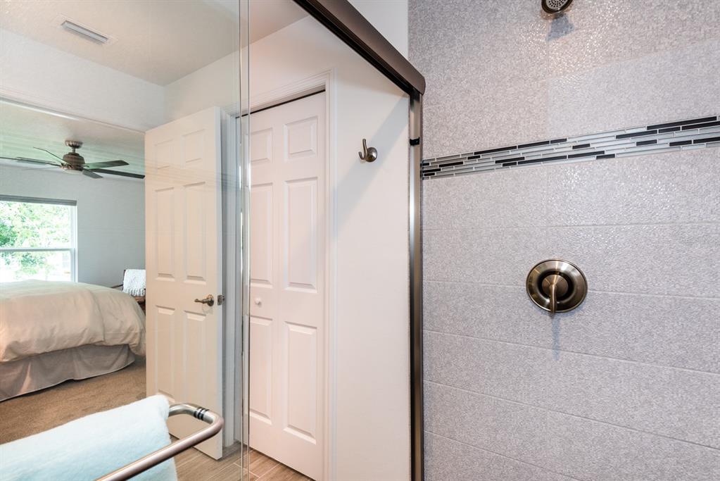 215 Lewis Circle, Unit 111 Punta Gorda, FL 33950 - Photo 36 of 43 a bathroom with a glass shower door