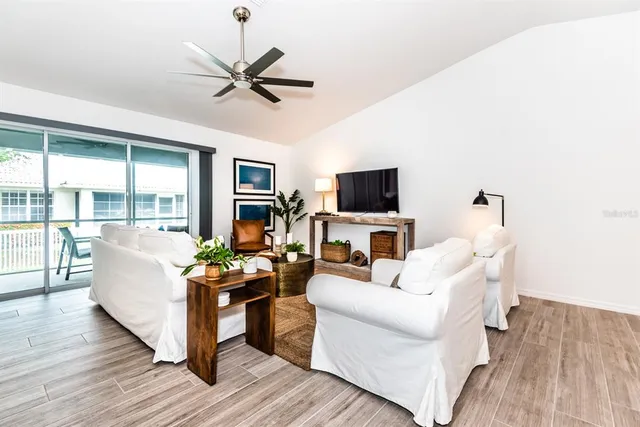 a living room with furniture a fireplace and a flat screen tv