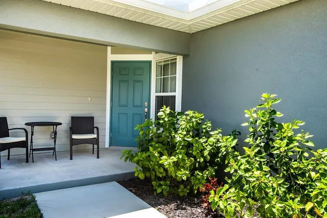 a view of a house with a porch and sitting area