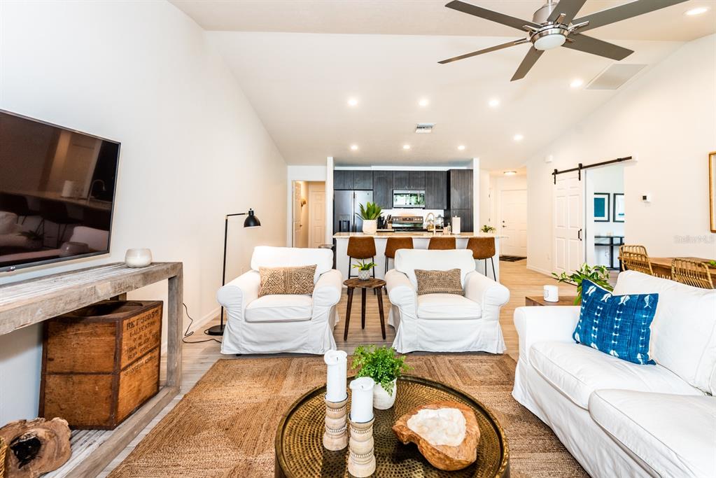 215 Lewis Circle, Unit 111 Punta Gorda, FL 33950 - Photo 7 of 43 a living room with fireplace furniture and a flat screen tv
