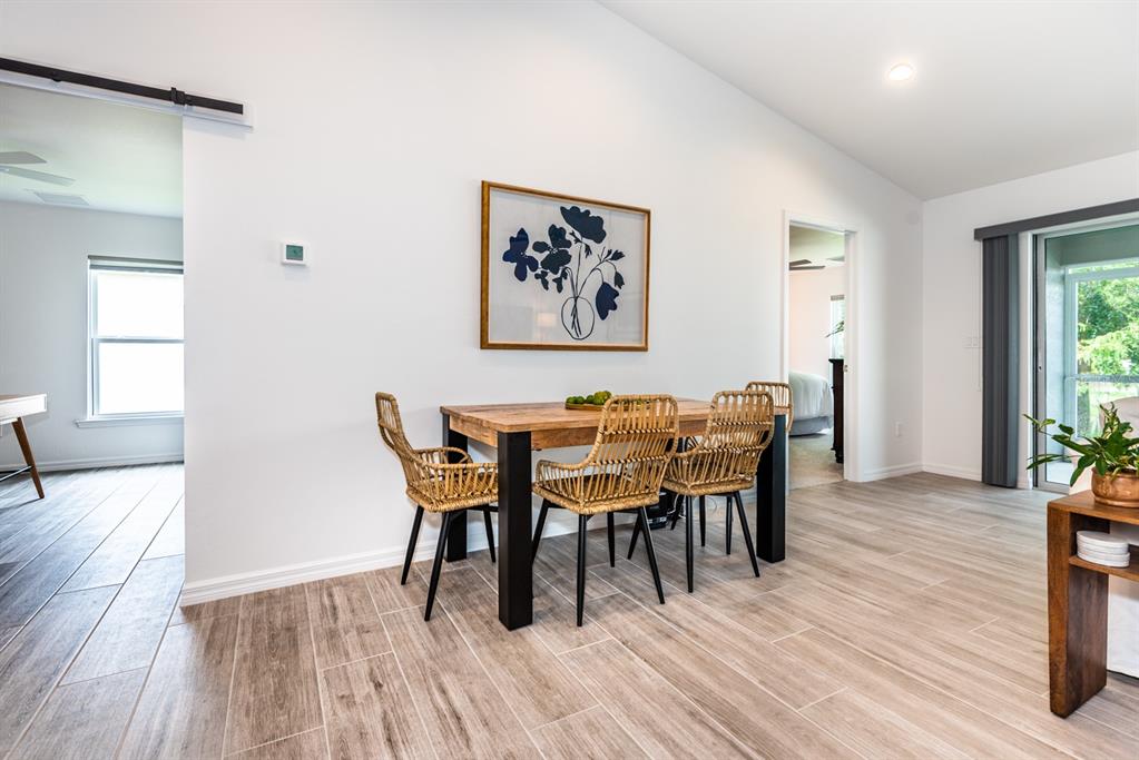 215 Lewis Circle, Unit 111 Punta Gorda, FL 33950 - Photo 8 of 43 a view of a dining room with furniture and wooden floor