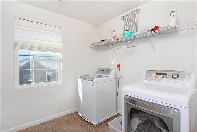 1044 Countess Lane Spring Hill, TN 37174 - Photo 10 of 20 Doing the laundry is easier when you have lots of room to work with. Nice shelving to help keep everything neat & tidy.