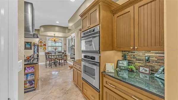 a kitchen with stainless steel appliances granite countertop a refrigerator and a stove