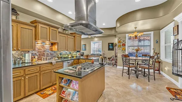 a kitchen with a table chairs stove and cabinets