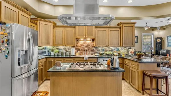 a kitchen with stainless steel appliances granite countertop a sink and cabinets