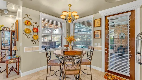 a dining room with furniture and chandelier