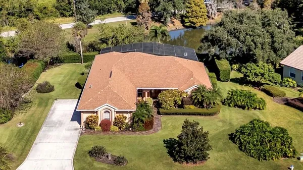 an aerial view of a house with yard swimming pool and outdoor seating