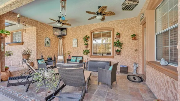 a view of a patio with table and chairs and potted plants