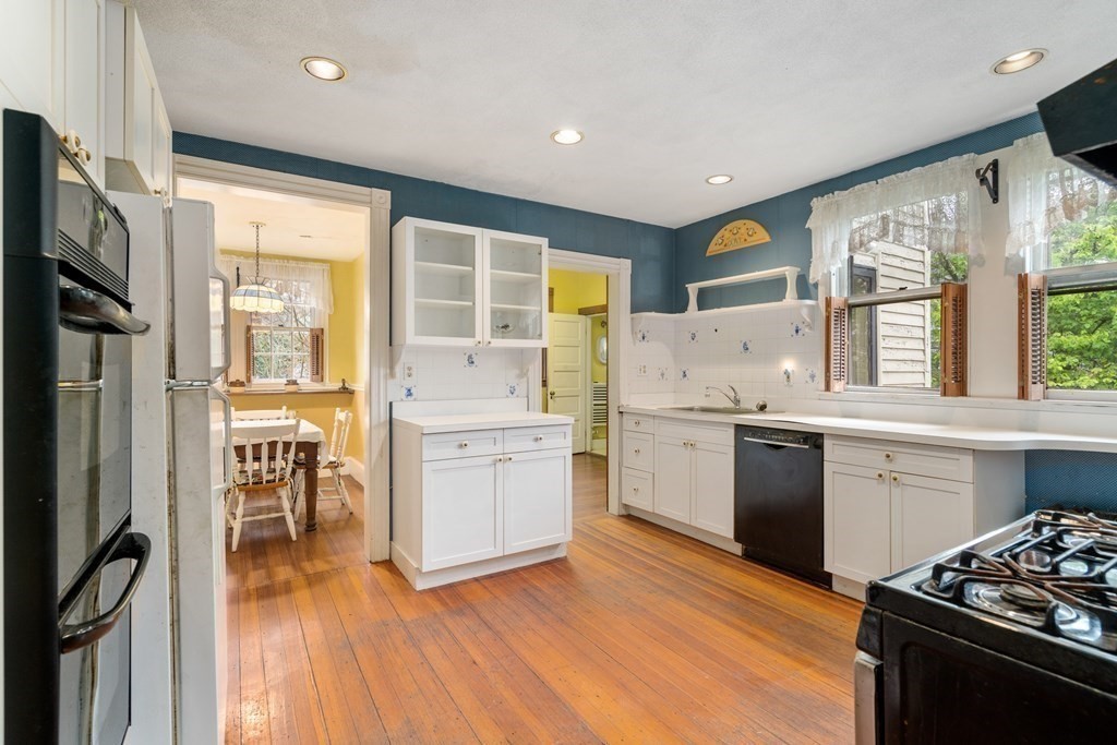 13 Ravine Street Arlington, MA 02476 - Photo 12 of 42 a kitchen with a stove a sink and a refrigerator