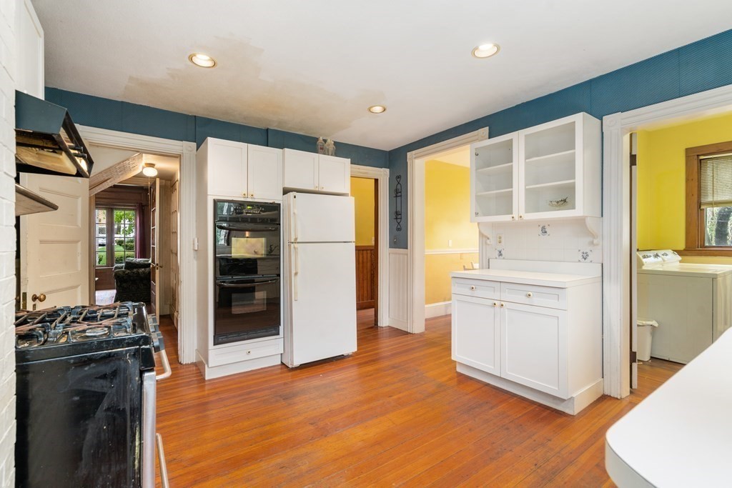 13 Ravine Street Arlington, MA 02476 - Photo 13 of 42 a kitchen with a refrigerator and a stove top oven