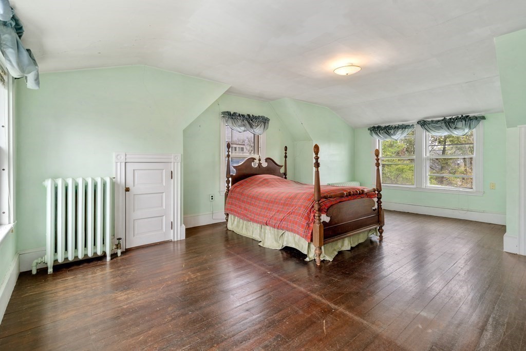 13 Ravine Street Arlington, MA 02476 - Photo 15 of 42 a bedroom with a bed and wooden floor