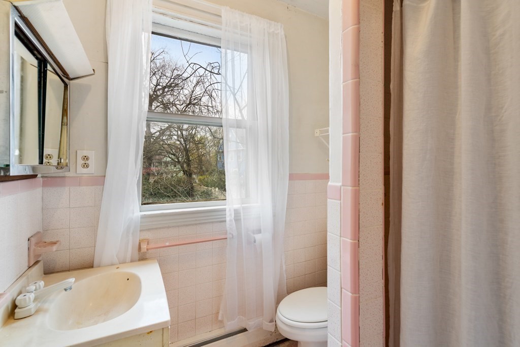 13 Ravine Street Arlington, MA 02476 - Photo 21 of 42 a white toilet sitting next to a bathroom sink