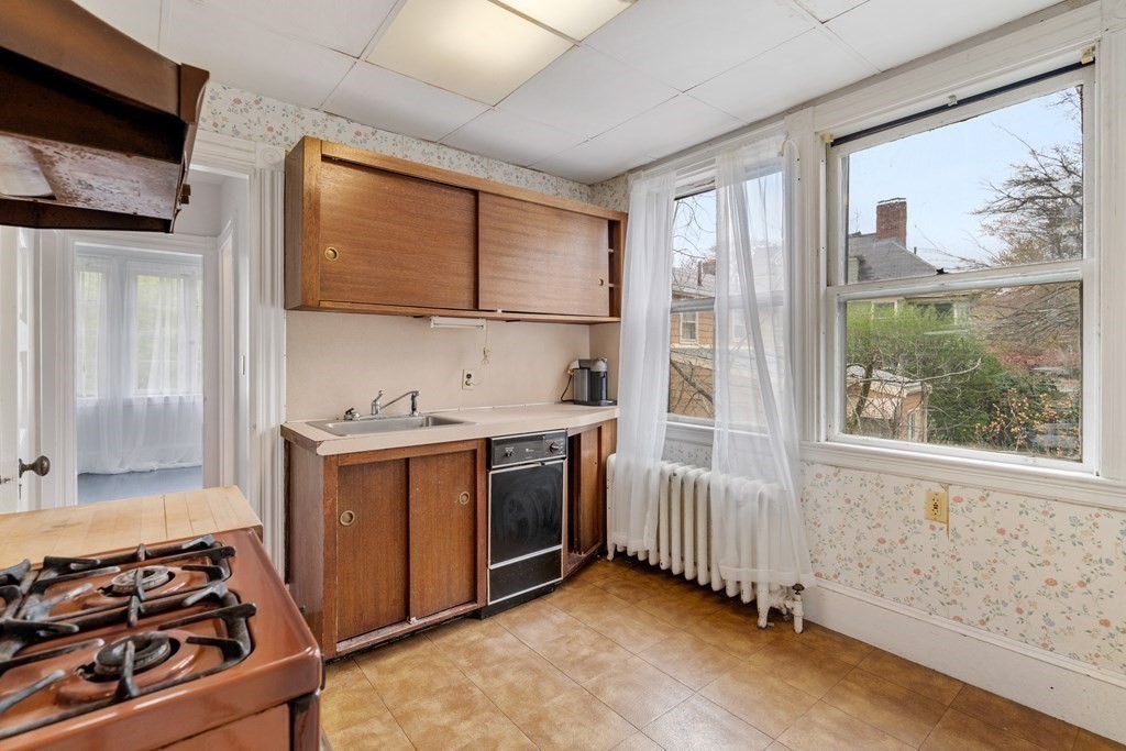 13 Ravine Street Arlington, MA 02476 - Photo 24 of 42 a kitchen with stainless steel appliances granite countertop a stove and a refrigerator