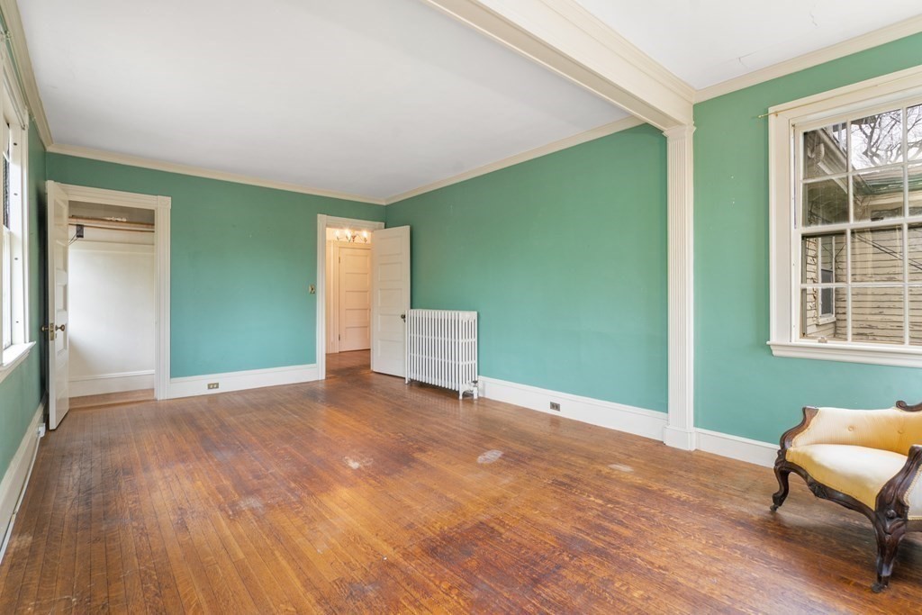 13 Ravine Street Arlington, MA 02476 - Photo 26 of 42 a view of an empty room with window and wooden floor