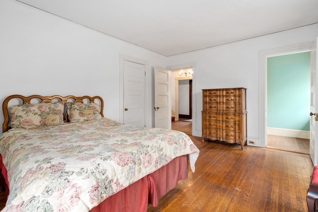 13 Ravine Street Arlington, MA 02476 - Photo 27 of 42 a spacious bedroom with a bed and wooden floor