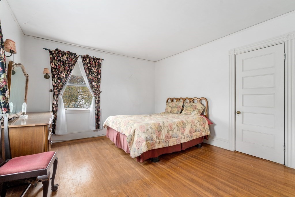 13 Ravine Street Arlington, MA 02476 - Photo 29 of 42 a bedroom with a bed windows and wooden floor