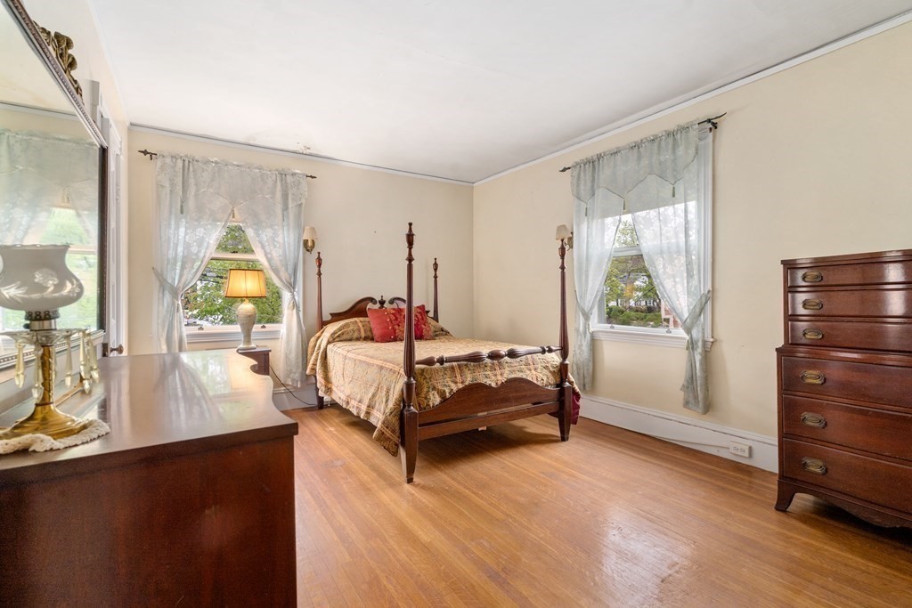 13 Ravine Street Arlington, MA 02476 - Photo 30 of 42 a bedroom with a bed a mirror and a window