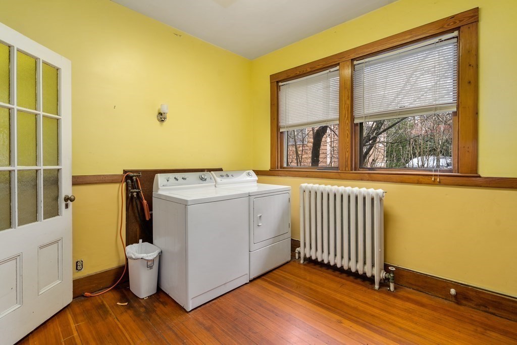 13 Ravine Street Arlington, MA 02476 - Photo 31 of 42 a view of a utility room with a window and wooden floor