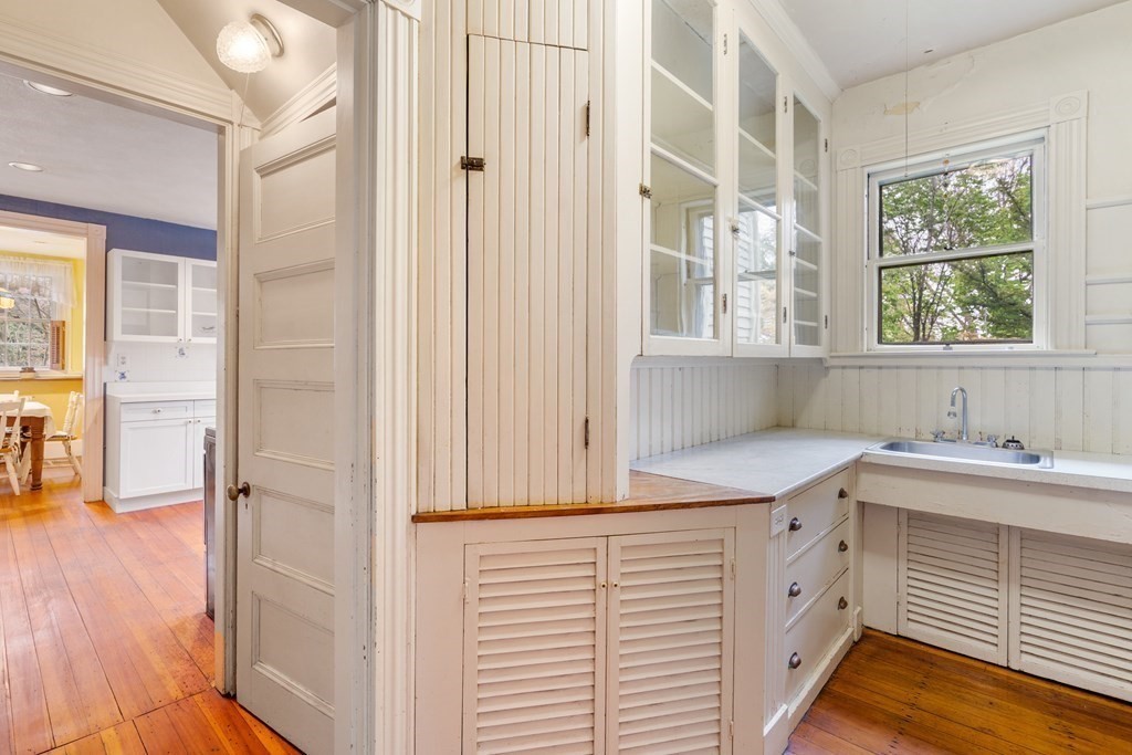 13 Ravine Street Arlington, MA 02476 - Photo 7 of 42 a kitchen with a white wooden cabinets and a sink