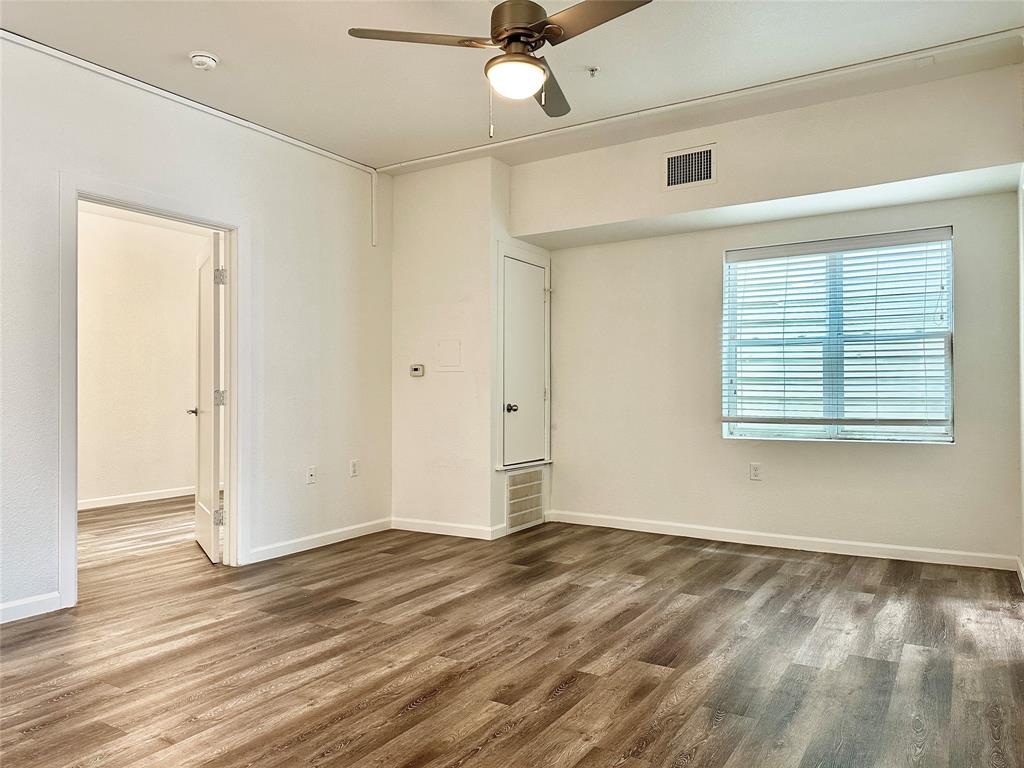 911 West 22nd Street, Unit 203 Austin, TX 78705 - Photo 5 of 13 a view of an empty room with wooden floor and a window