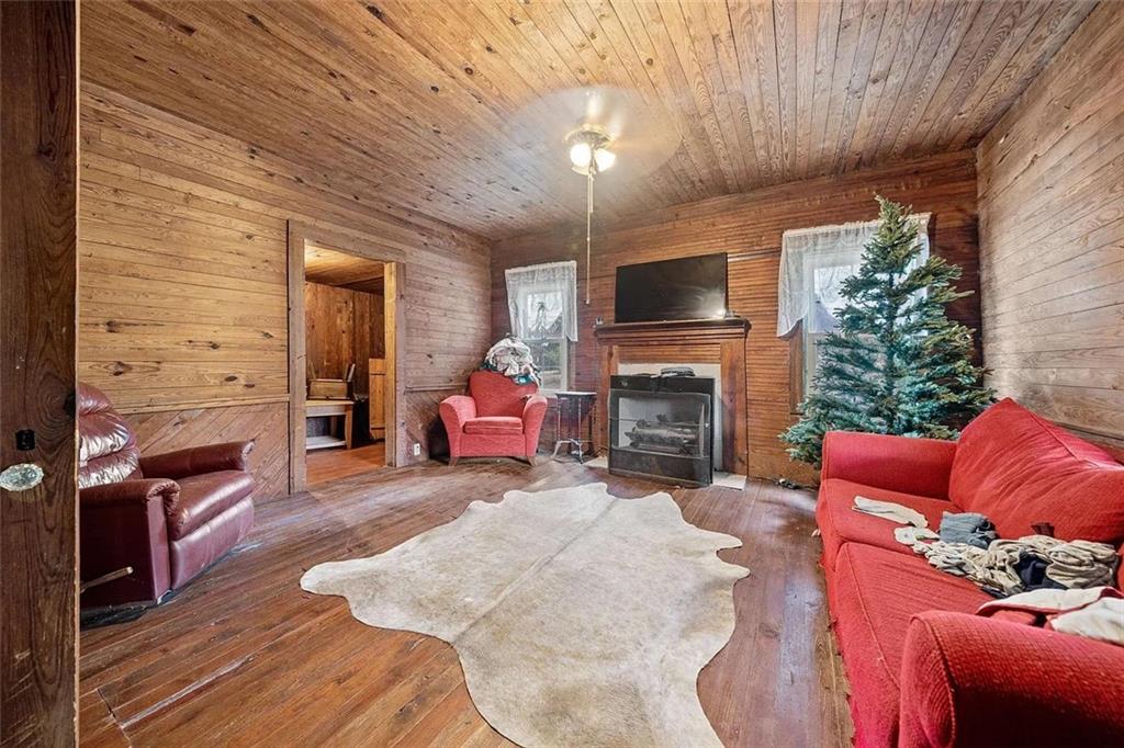 904 Rabun Road Sparta, GA 31087 - Photo 9 of 9 a living room with furniture a fireplace and a flat screen tv