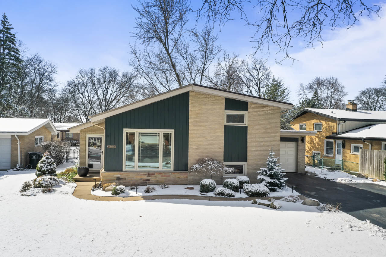 5 East Sunset Road Mount Prospect, IL 60056 - Photo 3 of 46 a front view of a house with yard outdoor seating and covered with trees