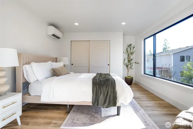 a bedroom with a large bed and a large window