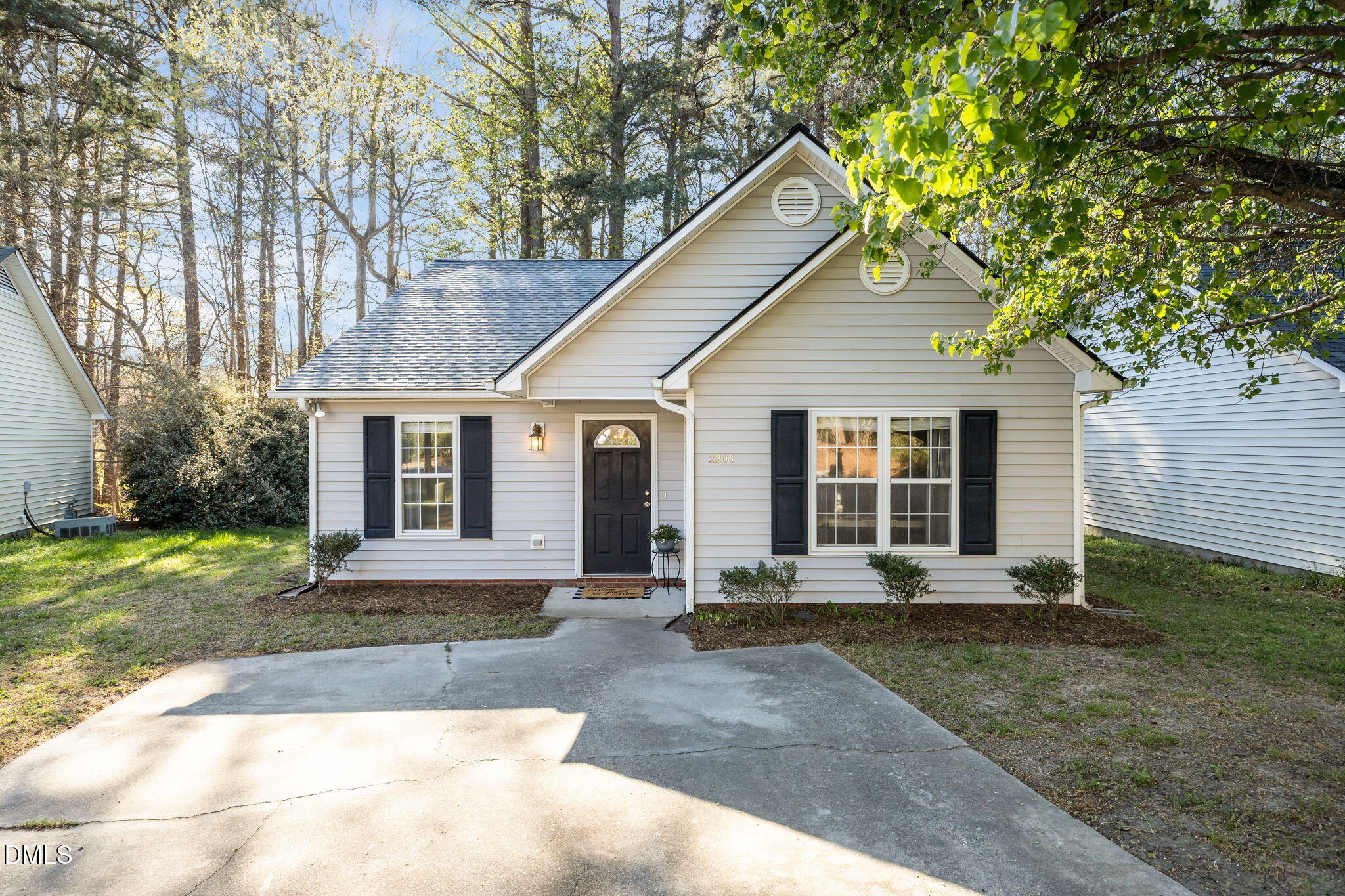 a front view of a house with a yard and trees