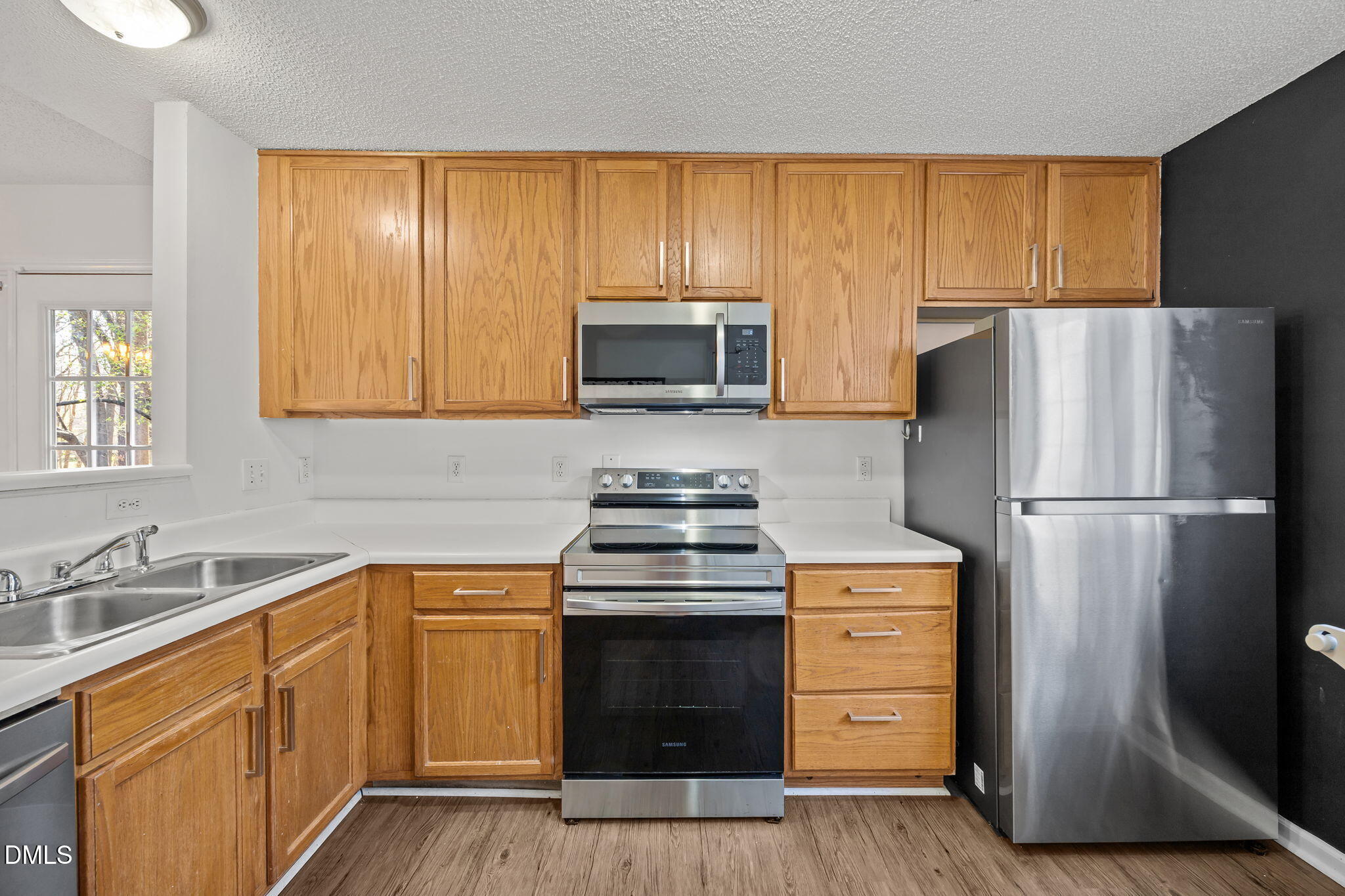2208 Walnut Ridge Court Raleigh, NC 27610 - Photo 16 of 24 a kitchen with granite countertop wooden cabinets and stainless steel appliances