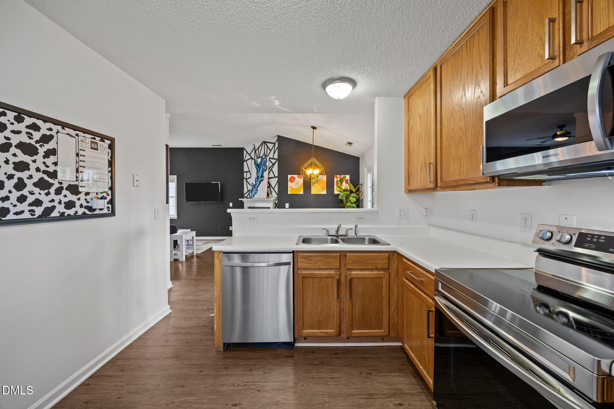 2208 Walnut Ridge Court Raleigh, NC 27610 - Photo 17 of 24 a kitchen with a sink stove and microwave