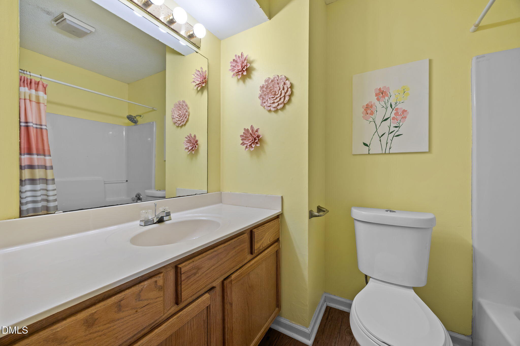 2208 Walnut Ridge Court Raleigh, NC 27610 - Photo 20 of 24 a bathroom with a toilet sink and mirror