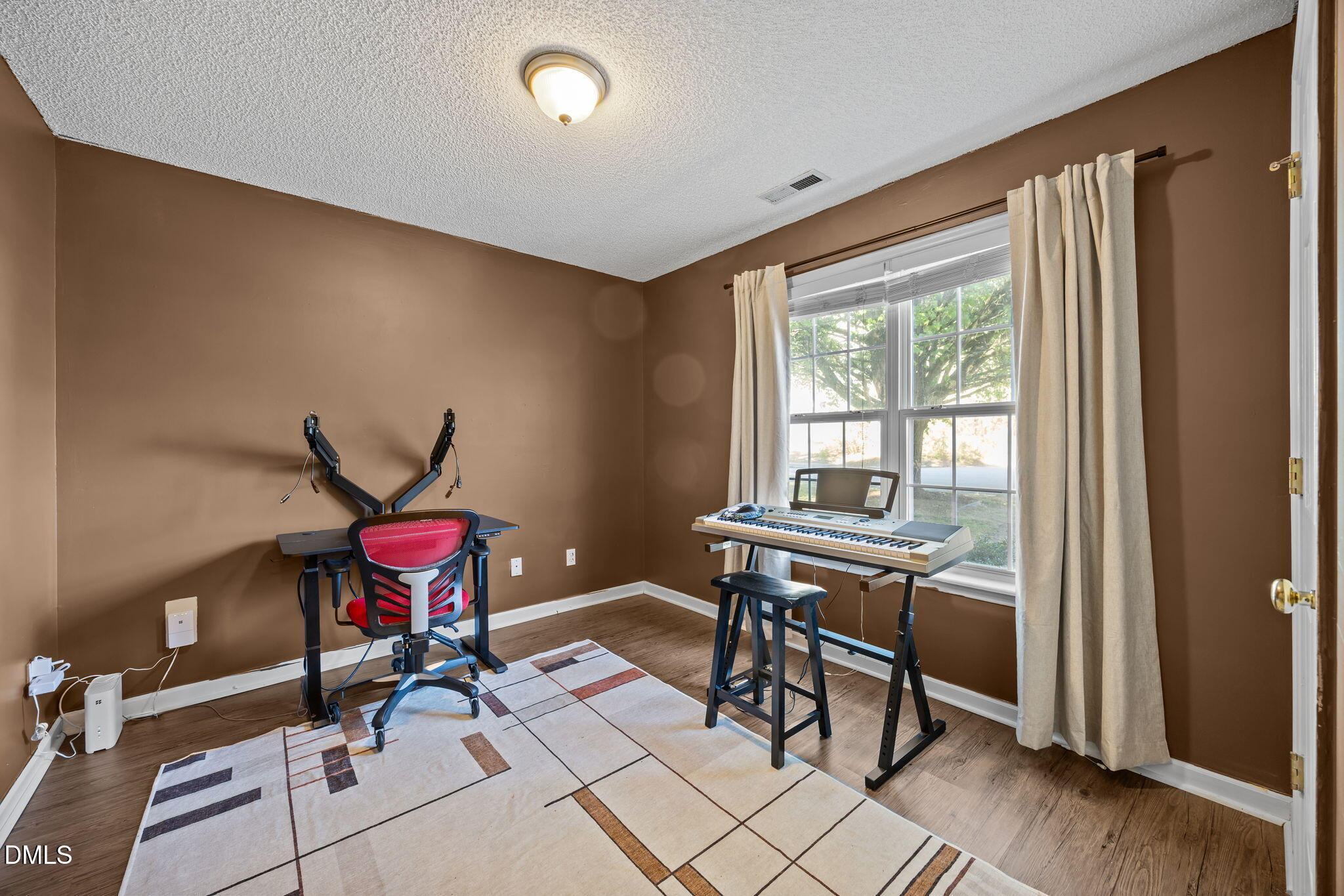 2208 Walnut Ridge Court Raleigh, NC 27610 - Photo 23 of 24 a view of a workspace with furniture and a window