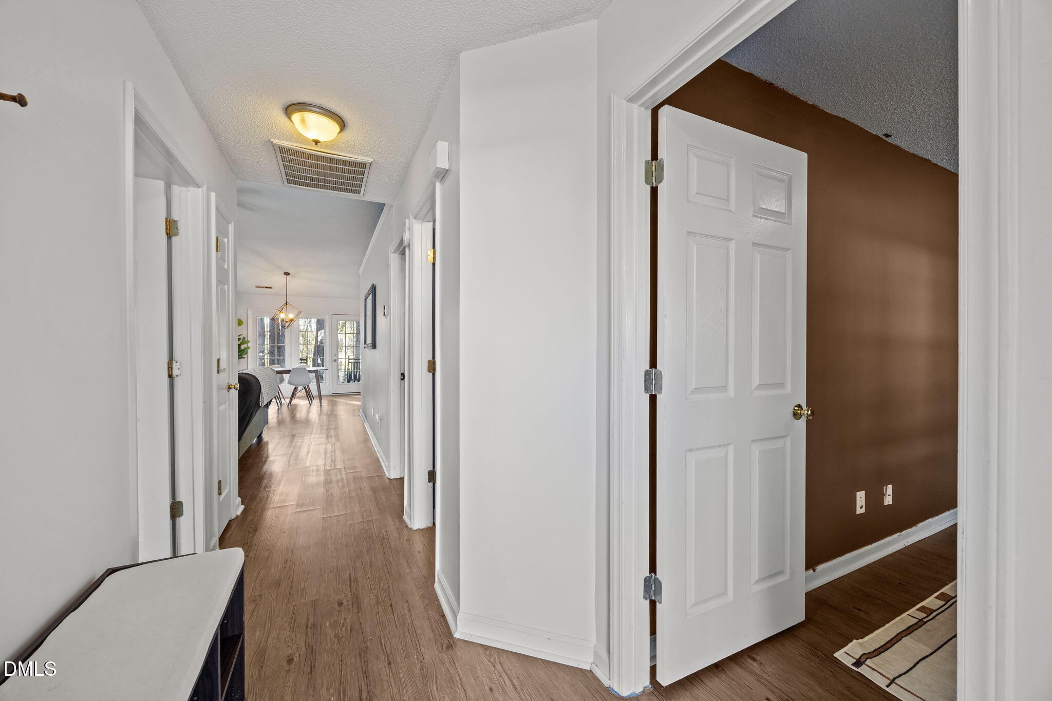 2208 Walnut Ridge Court Raleigh, NC 27610 - Photo 10 of 24 a view of a hallway with wooden floor and dining room