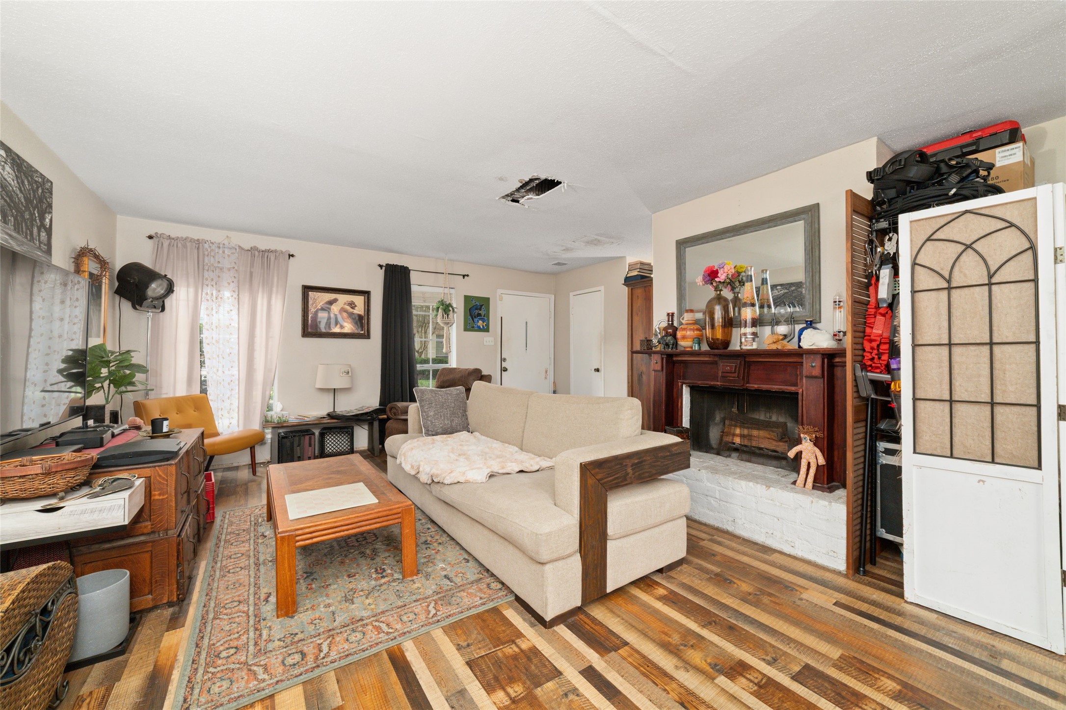 5800 Lumberdale Road, Unit 55 Houston, TX 77092 - Photo 8 of 34 a living room with furniture a fireplace and a flat screen tv