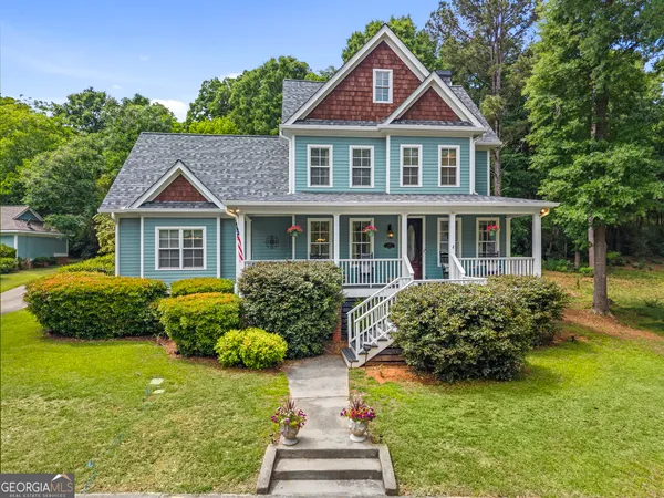 a front view of house with yard and green space