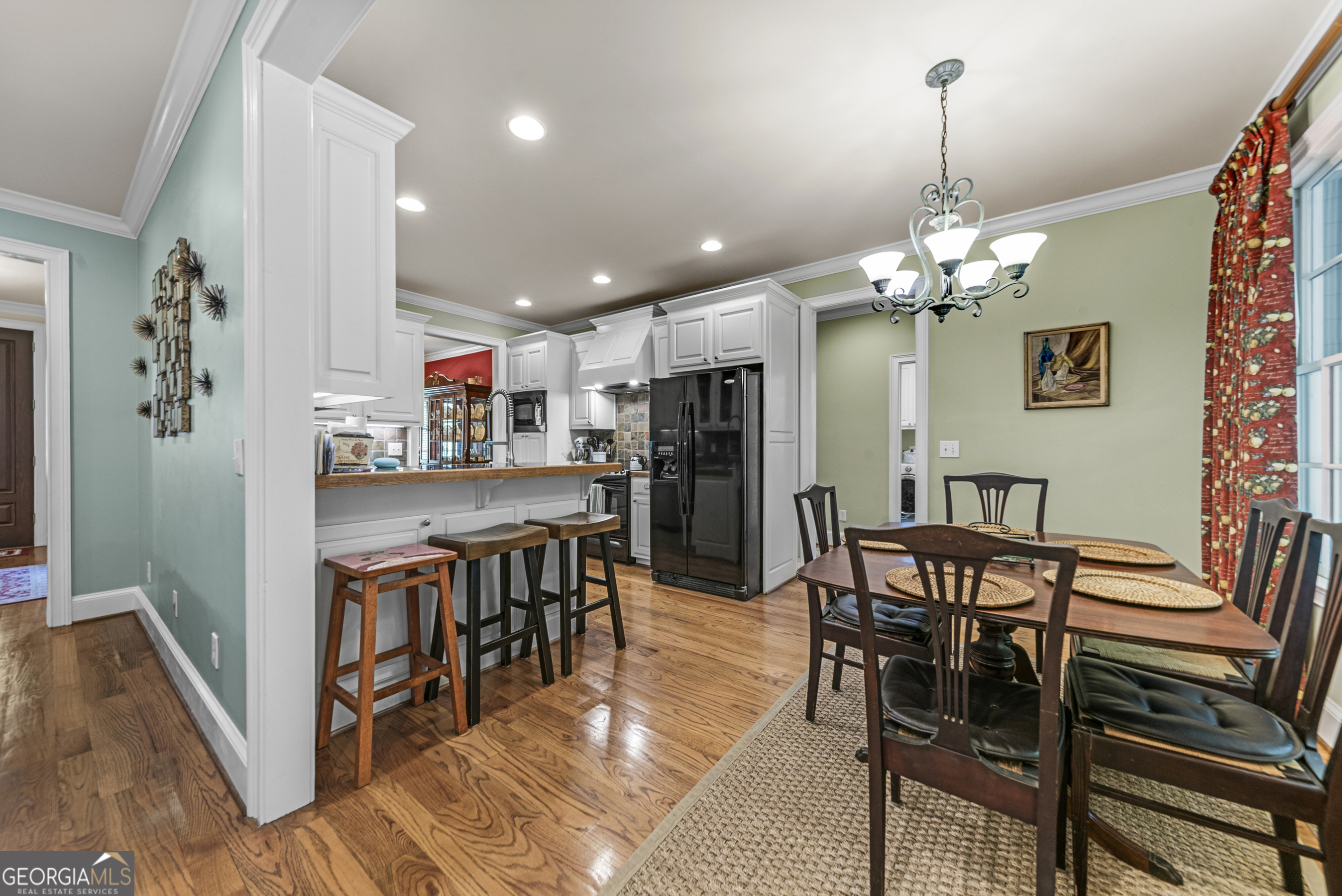 524 Hillside Road Madison, GA 30650 - Photo 16 of 54 a view of a dining room with furniture and chandelier