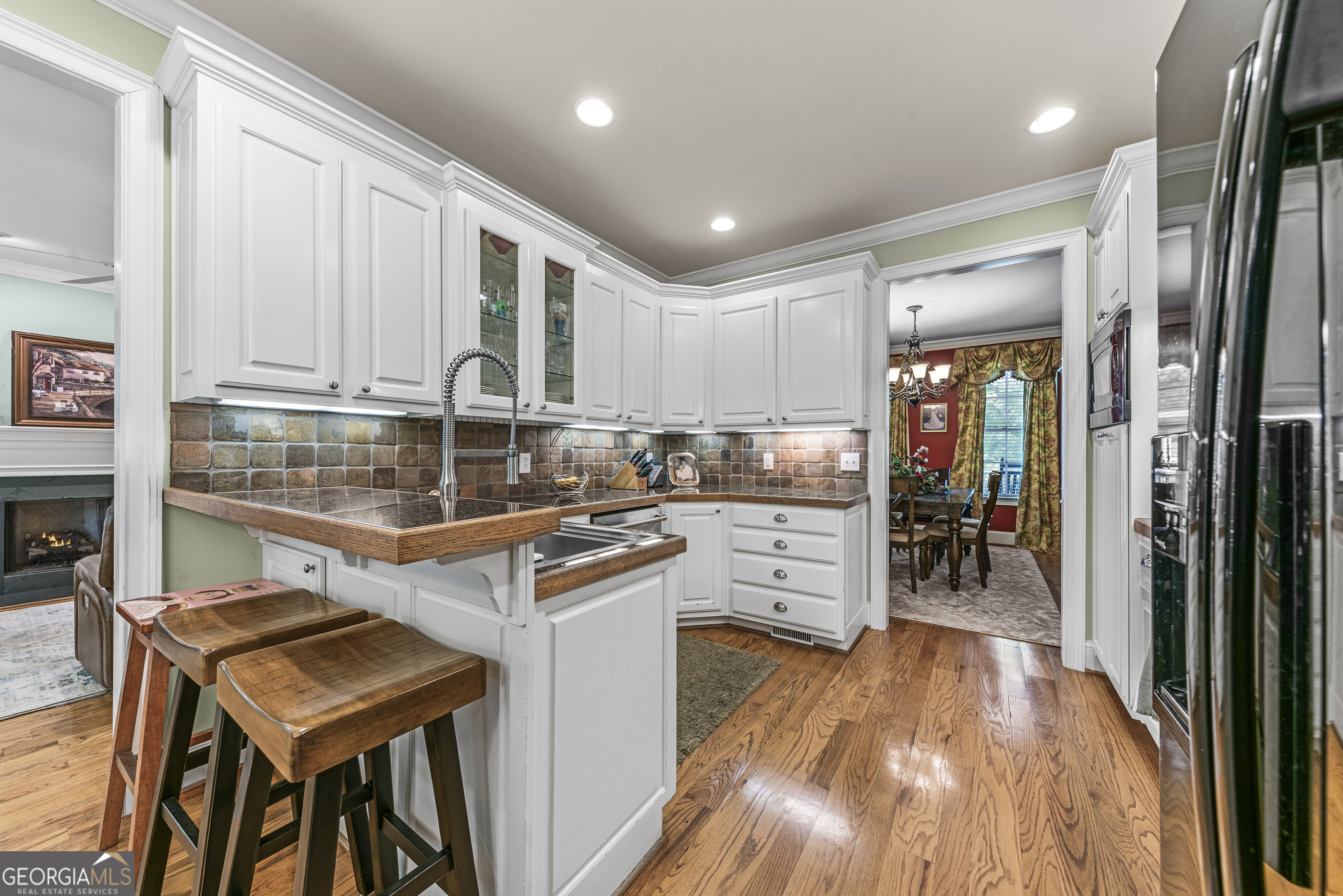 524 Hillside Road Madison, GA 30650 - Photo 20 of 54 a kitchen with a refrigerator a stove top oven a sink dishwasher and wooden cabinets with wooden floor