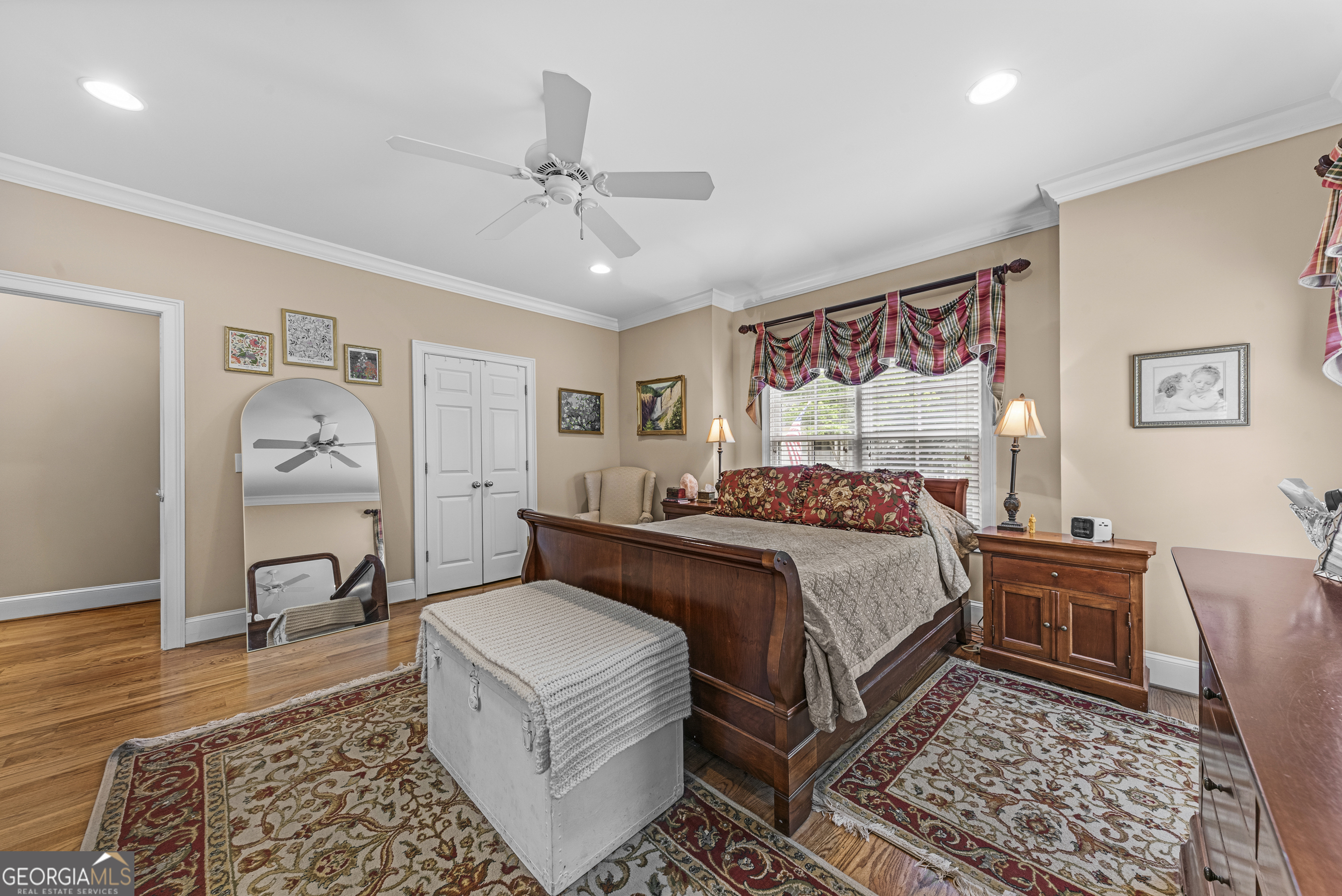 524 Hillside Road Madison, GA 30650 - Photo 26 of 54 a bed room with a bed and a chandelier