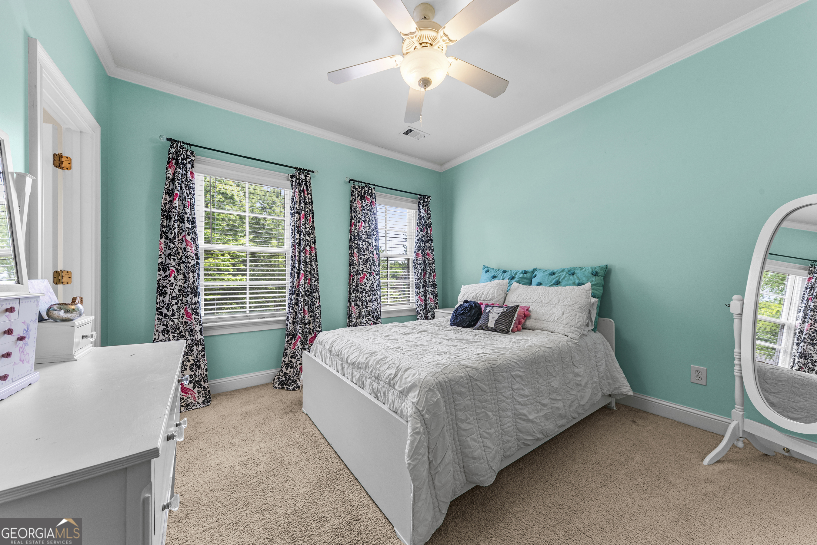 524 Hillside Road Madison, GA 30650 - Photo 38 of 54 a bedroom with a bed and a chandelier