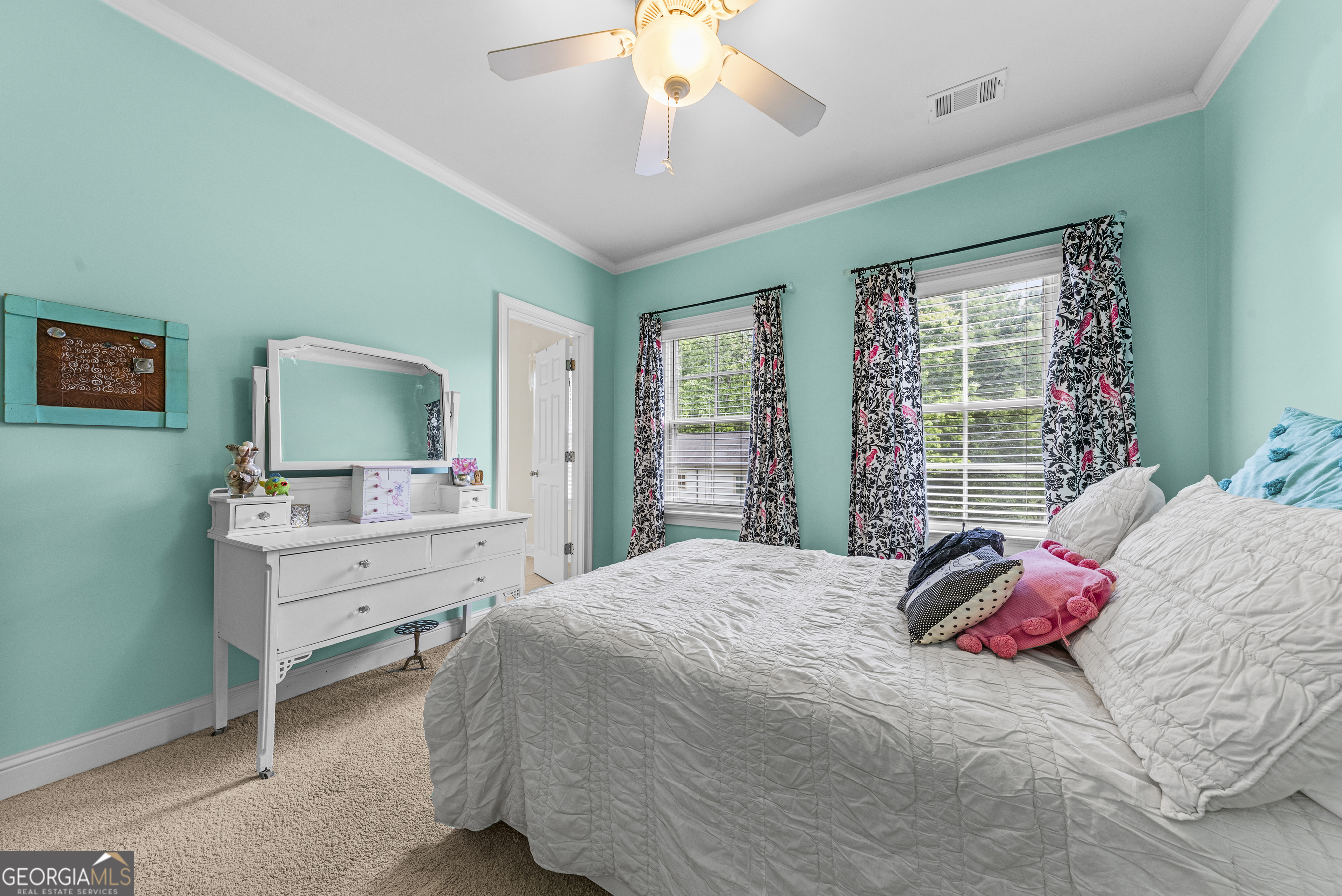 524 Hillside Road Madison, GA 30650 - Photo 39 of 54 a bedroom with a bed and a chandelier