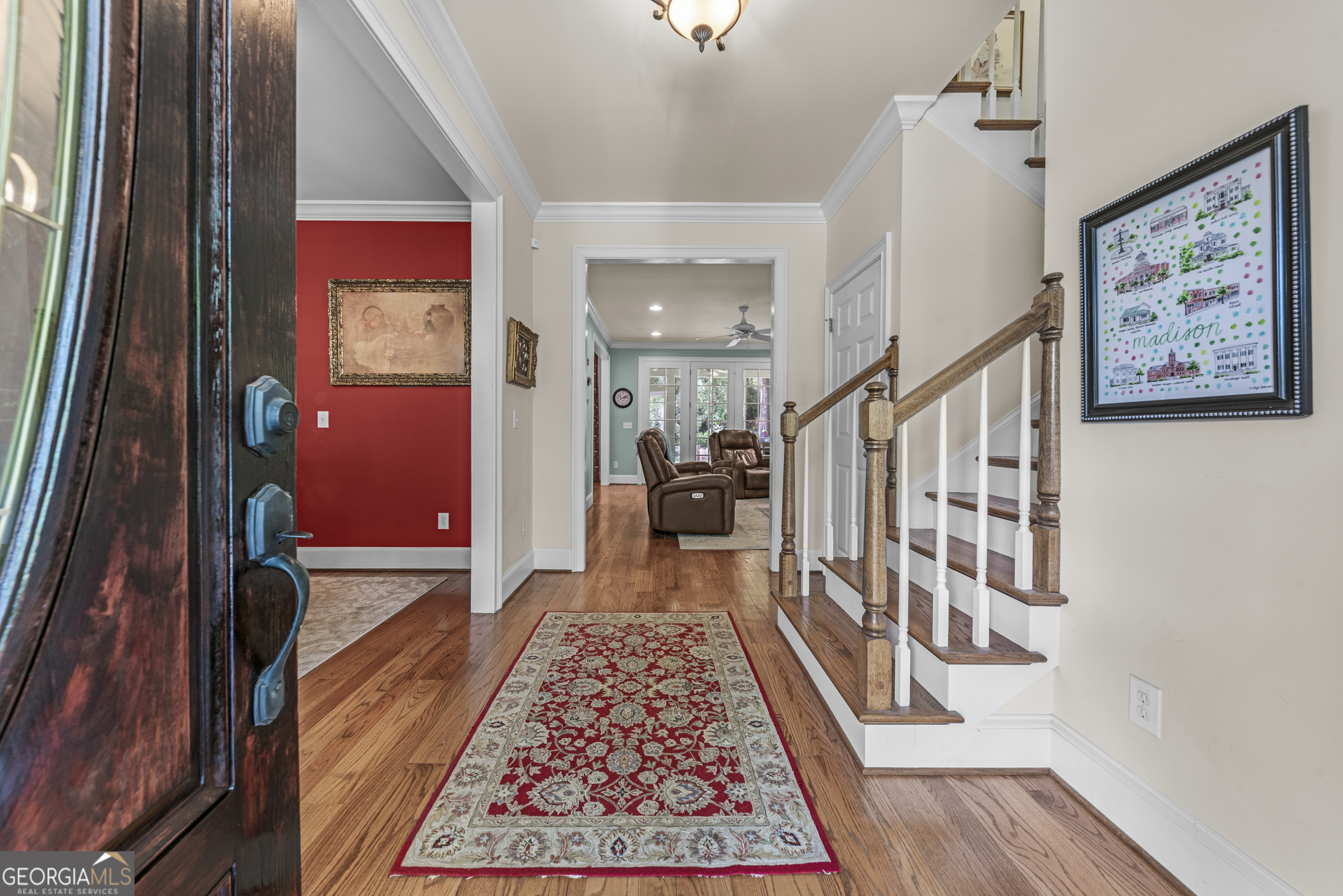 524 Hillside Road Madison, GA 30650 - Photo 7 of 54 a view of a hallway to a livingroom with wooden floor and a rug