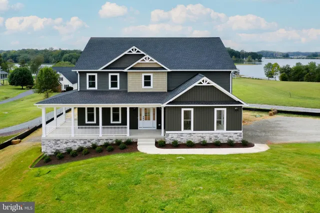 a front view of a house with a yard and balcony