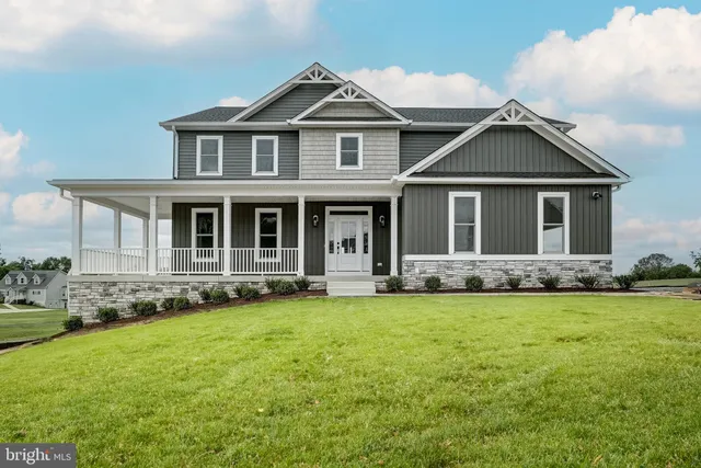 a view of empty room with wooden floor and fireplace