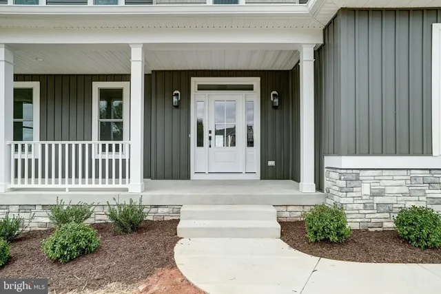 a view of an empty room with a window and a fireplace