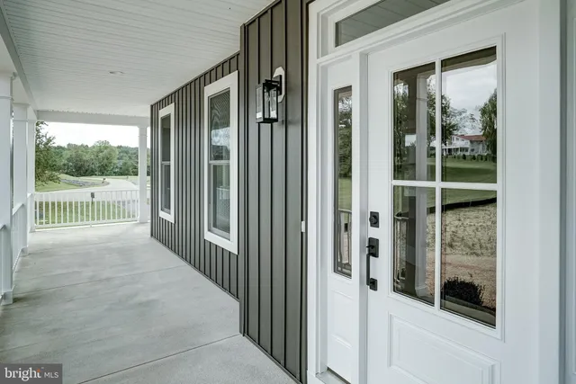 a view of an empty room with a fireplace and a cabinet