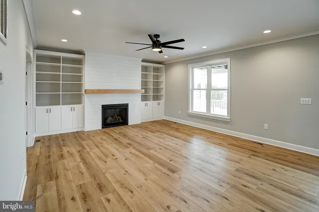 a view of a room with wooden floor and windows