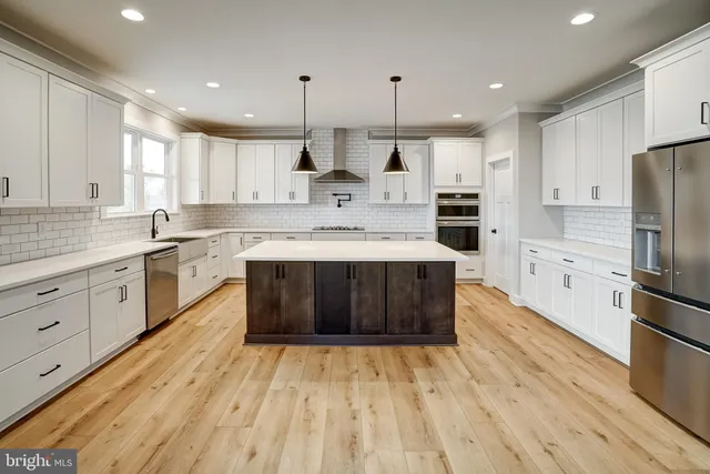 a kitchen with a sink a refrigerator and window
