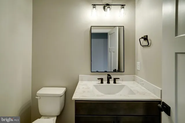 a bathroom with double sink and two mirror
