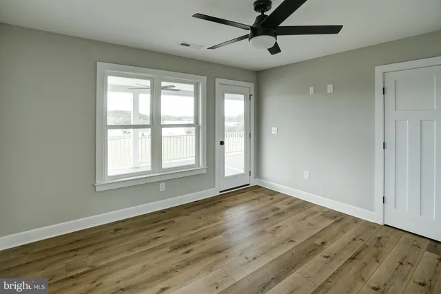 a large building with a big yard and large trees