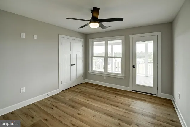 a large building with a big yard and more windows